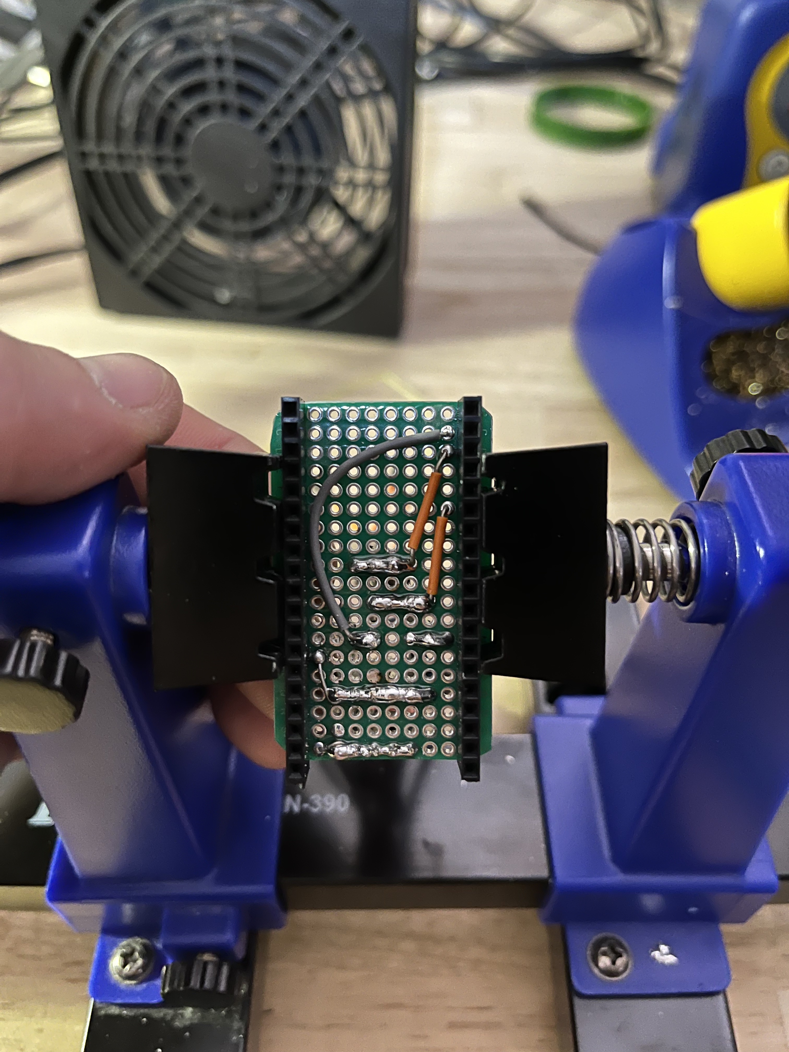 The back of the harness, where the ESP-32 plugs into. The bottom two rows are voltage / ground, the middle is button / resistor / neopixel pins, and the top two rows are I2C SDA and SCL buses